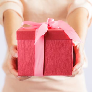 Young woman holding gift box