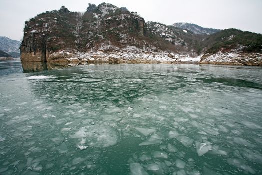 winter landscape with lake covered with ice frozen, south korea