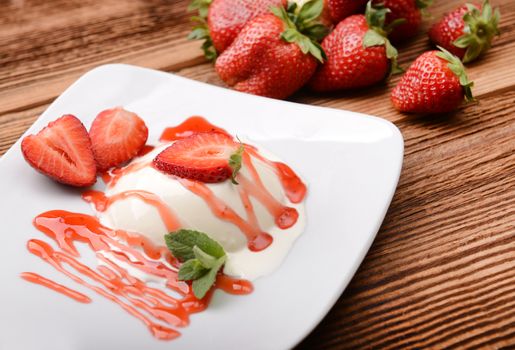 Italian dessert panna cotta with fresh strawberries