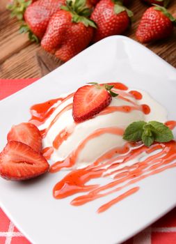 Italian dessert panna cotta with fresh strawberries