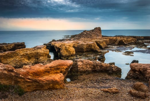 Rocky Coast with Ancient Ruins in the Mediterranean Sea in the Morning