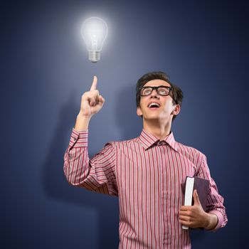 young man holding a book in front of him, raised his hand, the idea