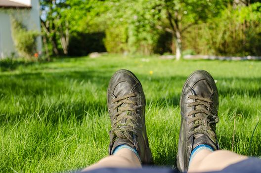 close up of women legs with sneakers climbing sharply fine grass