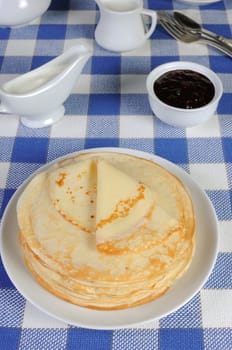 delicious pancakes on a plate with milk sauce