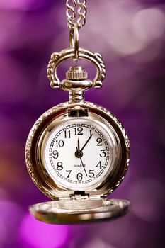 Quartz silver retro clock on a festive purple background