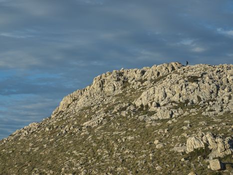 climber in the distance, climbing the hill on the island of Kornat