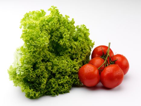 fresh raw lettuce and tomato over white background