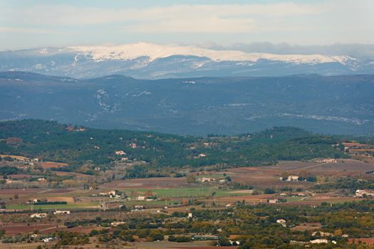 General landscape view from Luberon region with snow ridges of Alpes, Provence, France in winter season