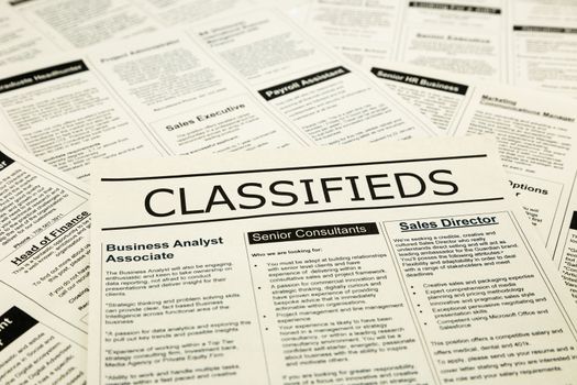 newspaper with advertisements and classifieds ads for vacancy, search for jobs