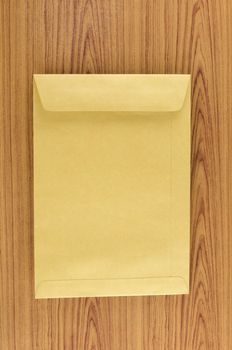 brown envelope on wood table background