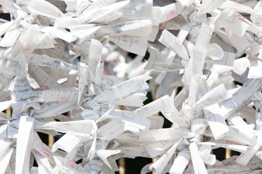 Tokyo, Japan - omikuji fortune paper hanged on a line in a temple