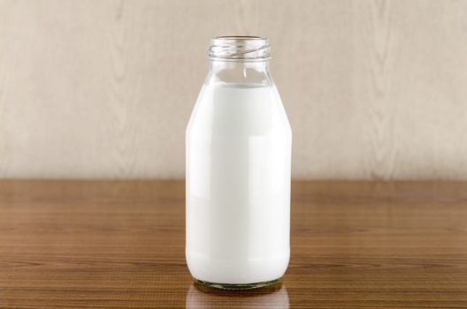 milk in a glass of bottle on wood table background