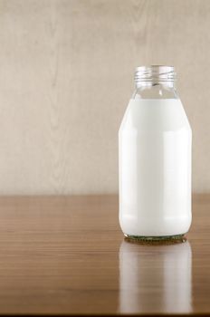 milk in a glass of bottle on wood table background