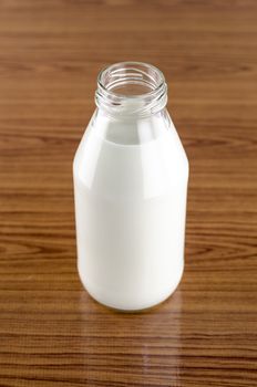milk in a glass of bottle on wood table background