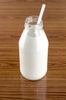 milk with straw in a glass of bottle