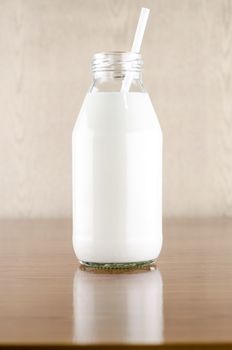 milk with straw in a glass of bottle