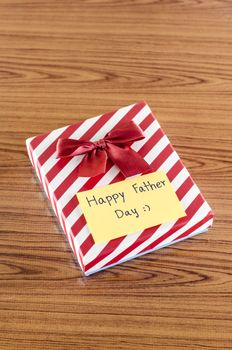 gift box with card write happy father day on wood background