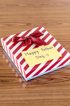 gift box with card write happy father day on wood background