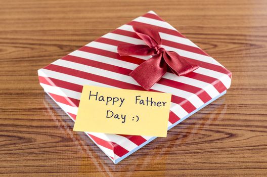 gift box with card write happy father day on wood background