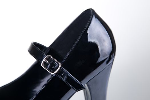 Close-up shot of a shoe strap, studio shot on gray background 