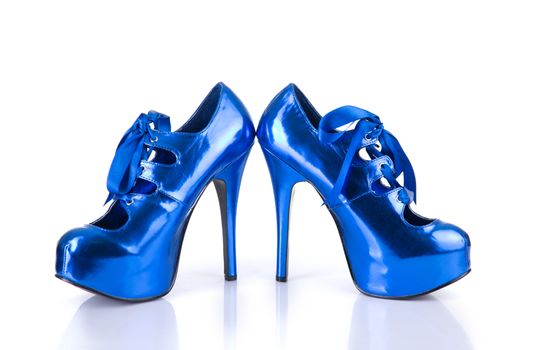 Elegant metallic blue female shoes, isolated on white background with natural reflection  