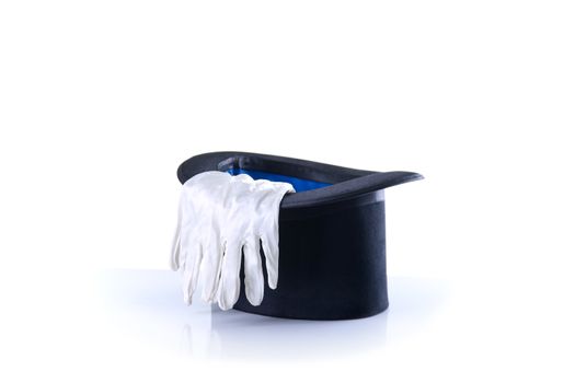 Black magician top hat with a pair of white gloves, isolated on white background 