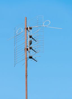 Old TV antenna on a background of blue sky
