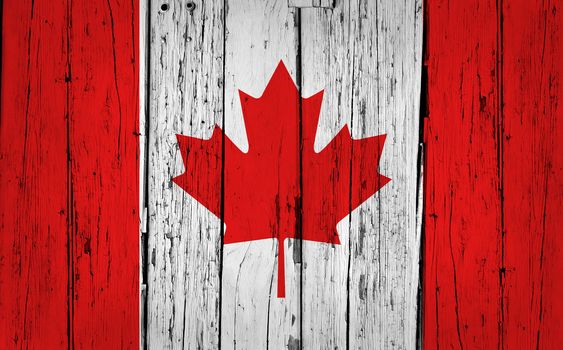 Canada grunge wood background with Canadian flag painted on aged wooden wall.