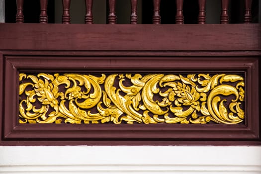 detail of wood carving with thai pattern on natural wood plate for decorated temple,Thailand