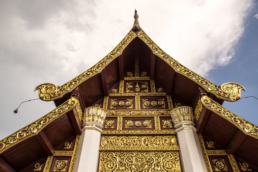 detail of wood carving with thai pattern on natural wood plate for decorated temple,Thailand