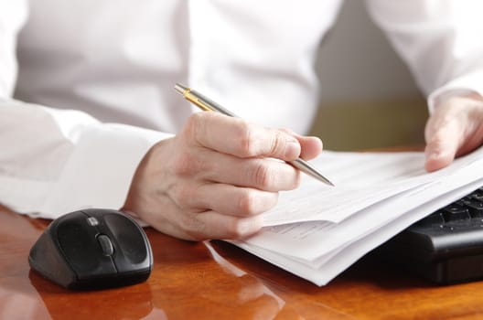 Hands with a document on a computer keyboard