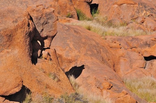Sandstone boulders in Namibia at sunrise. The shadow resembles a howling wolf.
