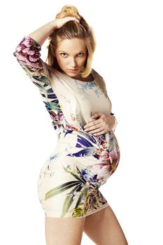 Portrait of pregnant woman, hand in hair. Isolated on white background.