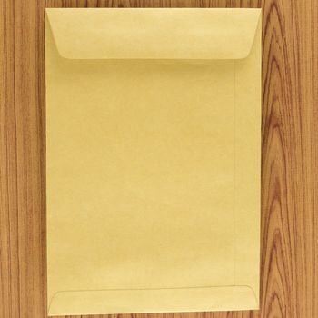 brown envelope on wood table background