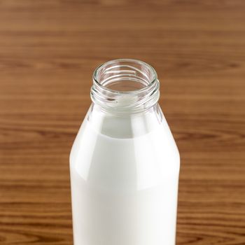 milk in a glass of bottle on wood table background