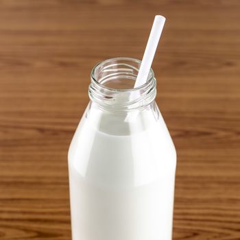 milk with straw in a glass of bottle