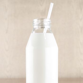 milk with straw in a glass of bottle