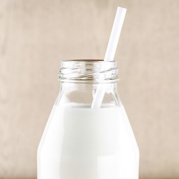 milk with straw in a glass of bottle