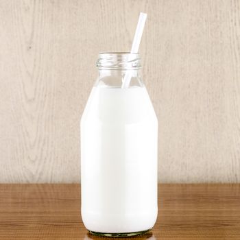 milk with straw in a glass of bottle