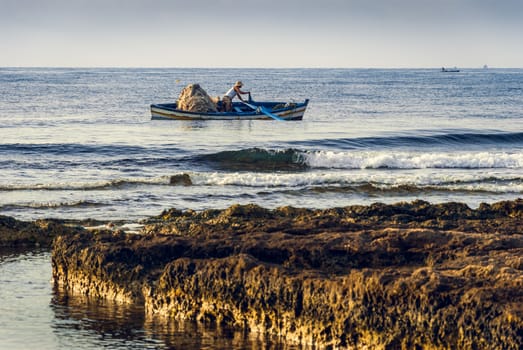 Fisherman in a Boat in the Morning