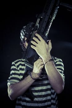 riot, prisoner in a prison with a machine gun