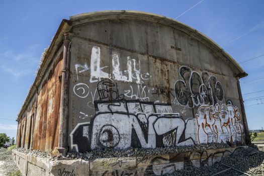 Grafitti, old abandoned train station, rusty iron walls