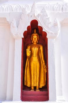 Buddha statues around the pagoda, Wat Phra Singh, Chiang Mai, Thailand.