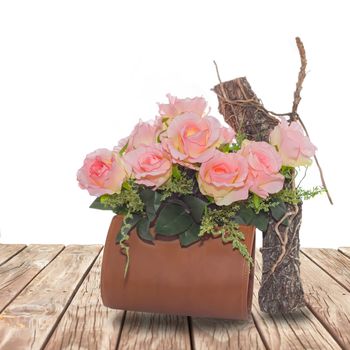 Summer rose flowers in bag on wood walk