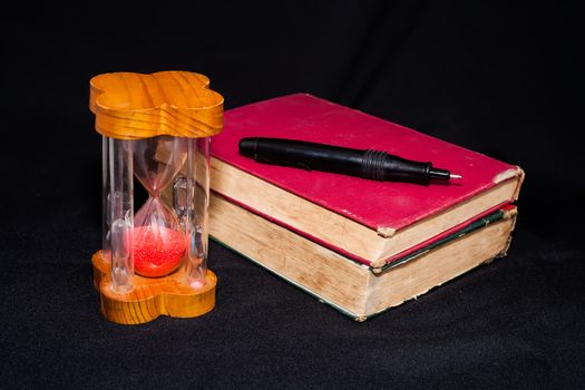 hourglass ,stopwatch and old book still life