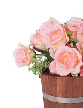 Summer flowers in wooden bucket on white background