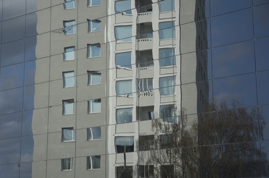 VALLINGBY, STOCKHOLM, SWEDEN ON APRIL 20, 2014: Fifties high rise residential building reflected in new glass architecture on April 20, 2014 in west suburb Vallingby, Stockholm, Sweden.