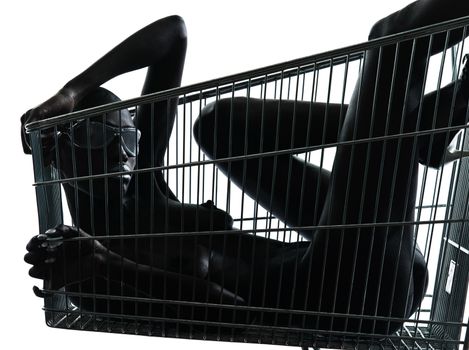 one beautiful black african naked woman sitting inside in a caddy shopping cart in studio isolated on white background