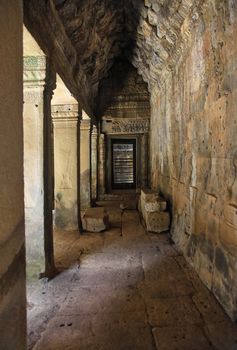 Long corridor of pillars in temple ruins. Bayon Temple of Angkor Thom