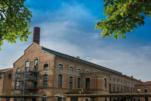 Industrial building with a tower and trees